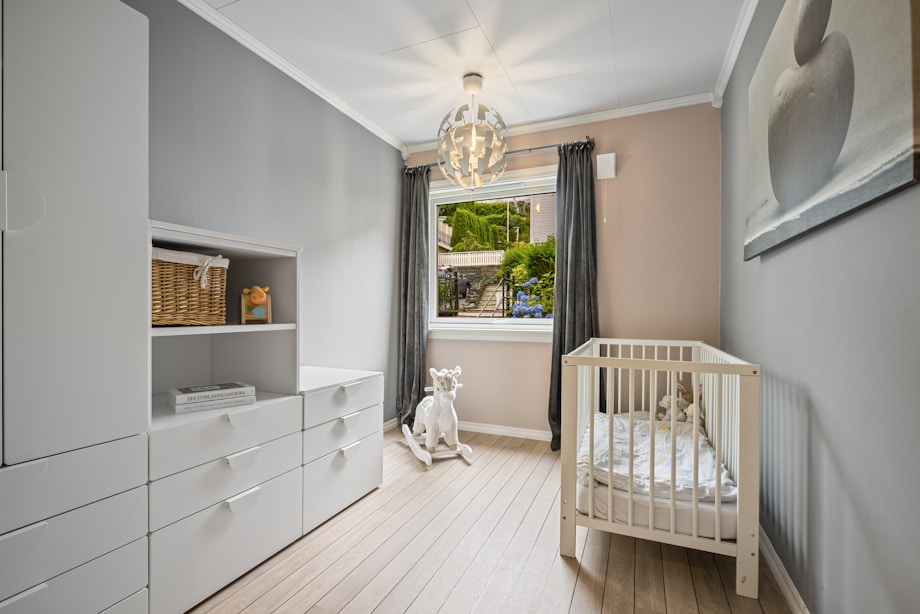 Compact British nursery with cot and dresser in a small room